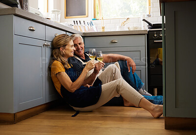Buy stock photo Love, senior couple and on kitchen floor, together and bonding while speaking, talking and with wine. Romantic, retirement or elderly man and woman being loving, romance and anniversary or discussion