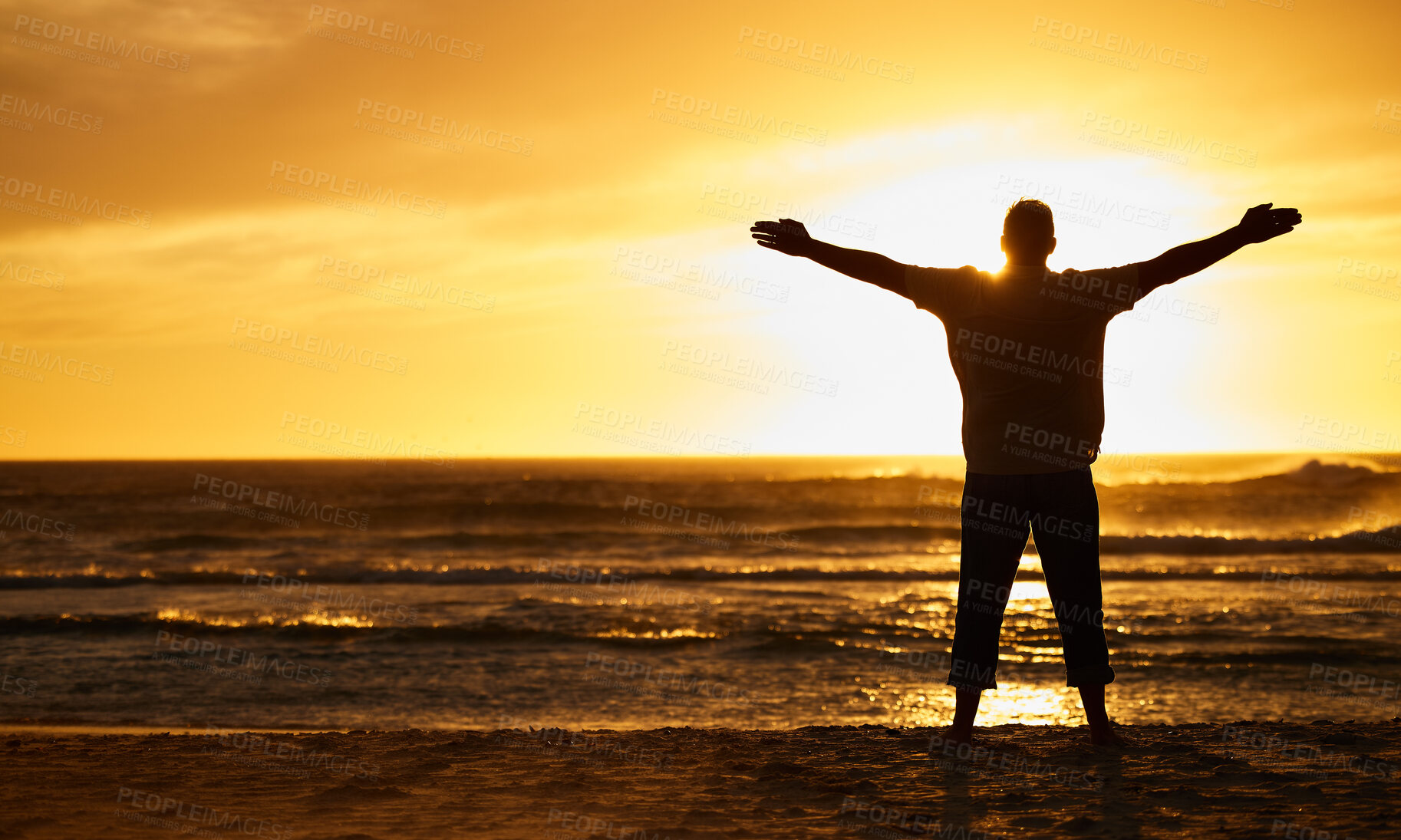 Buy stock photo Silhouette of man with view, sunset and beach with arms out by the ocean, carefree and peace, freedom on vacation outdoor. Free, sunshine and hands up, travel and adventure in nature, sea water.