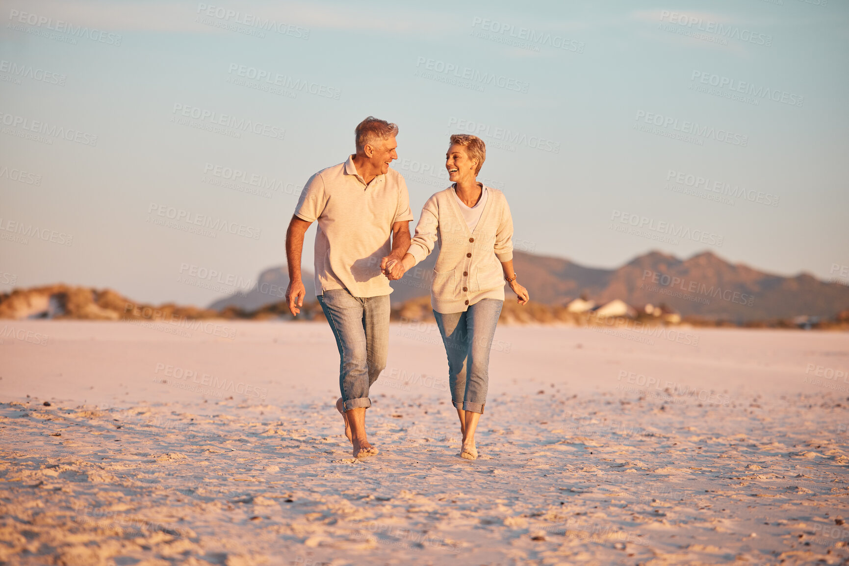 Buy stock photo Senior couple on beach, hand holding during retirement and travel, holiday together with love and care outdoor. Elderly, man and woman, romantic walk on the sand, blue sky and summer vacation.