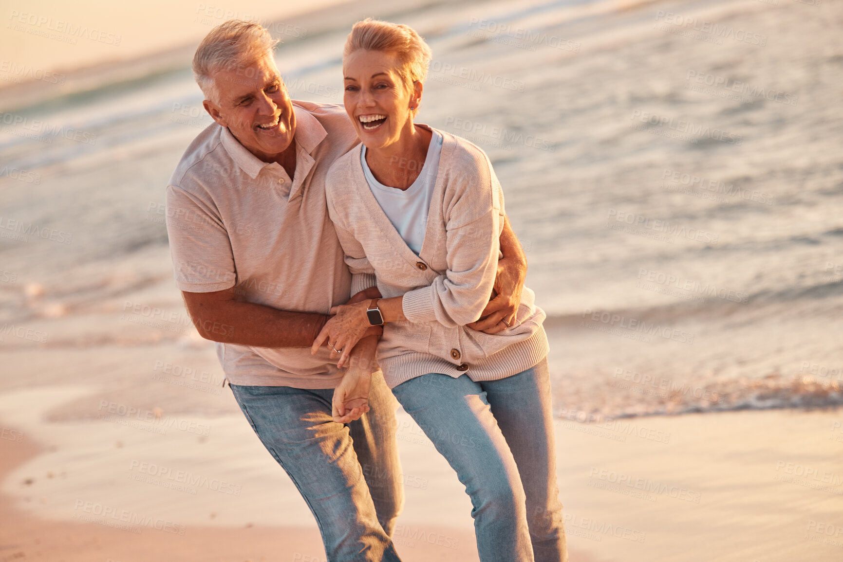 Buy stock photo Couple, retirement and travel to the beach, hug and love, fun together and spending quality time outdoor by the ocean. Senior man, woman and happy, smile on adventure and out in nature at sea.
