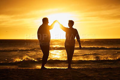 Buy stock photo Love, ocean and sunset, silhouette of couple on beach holding hands in Bali. Waves, romance and man and woman dancing in evening sun on romantic vacation spending time together in nature and sea sand