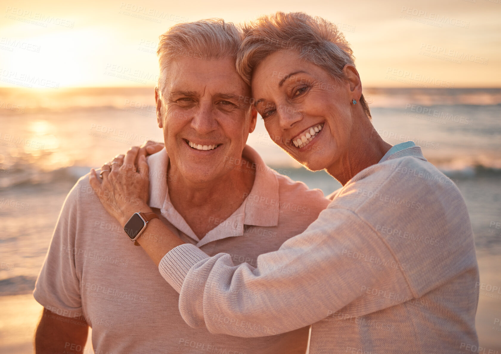 Buy stock photo Senior couple, beach portrait and hug on vacation, trip or summer holiday. Love, sunset and elderly, retired and happy man and woman on sea or ocean shore enjoying romantic time together outdoors.