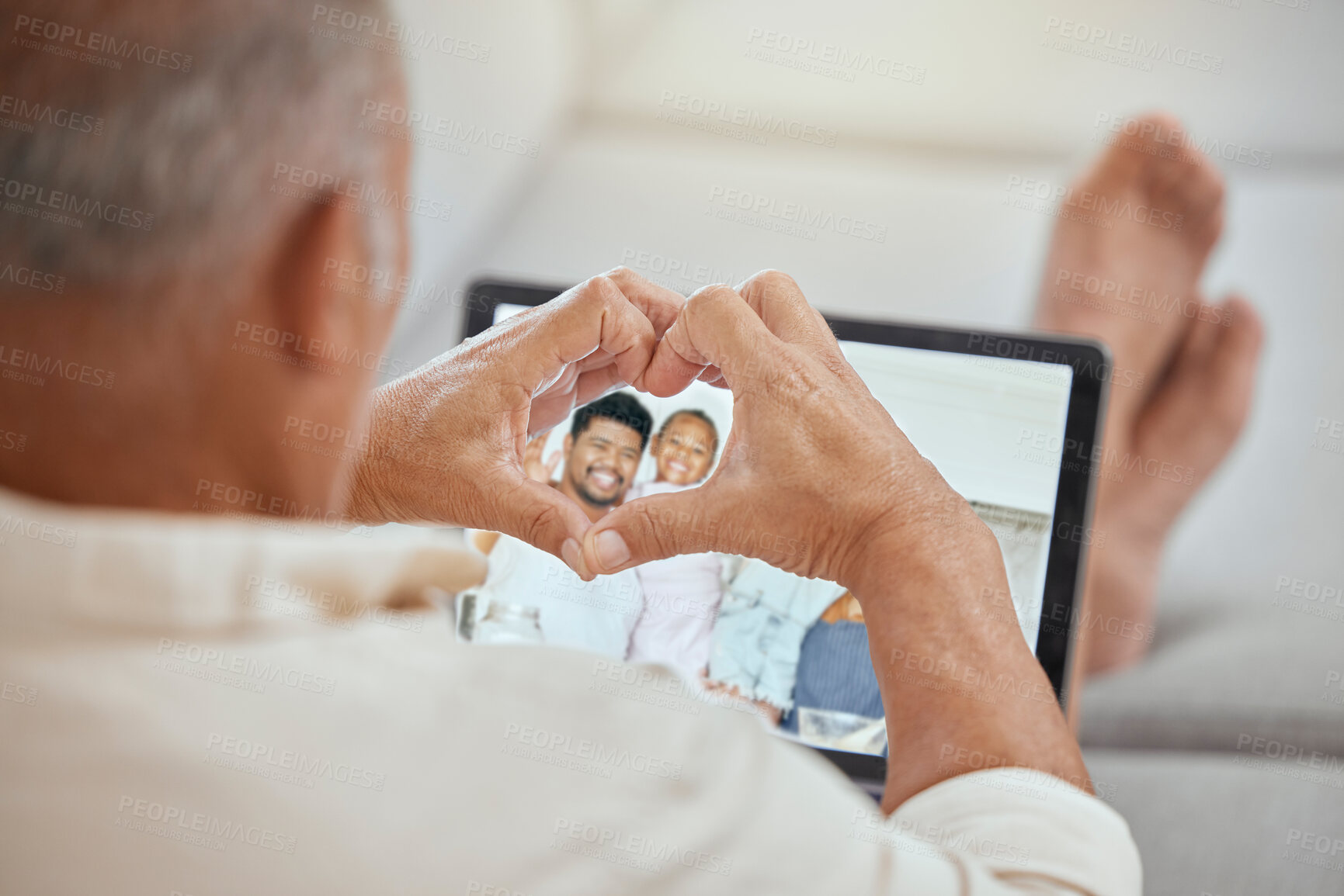 Buy stock photo Laptop, heart hands and video call with family, happy senior man relax on sofa in living room. Love, happy family and communication, a video call on screen and technology to connect people together.