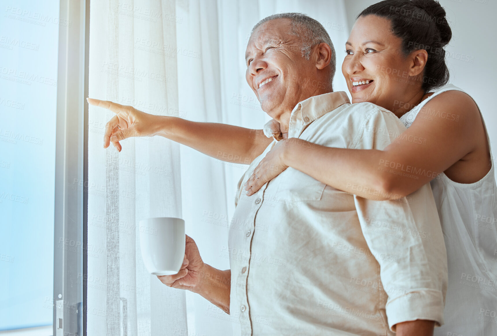 Buy stock photo Mature couple, hug or pointing out window in house, home or retirement holiday hotel with morning coffee. Smile, happy or elderly man and love woman in show hand gesture at bonding travel hospitality