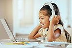 Girl, laptop and headphones with smile, music or video on desk in homeschool, learning and education, Child, computer and happy for podcast on internet, web or app by table in house for online class