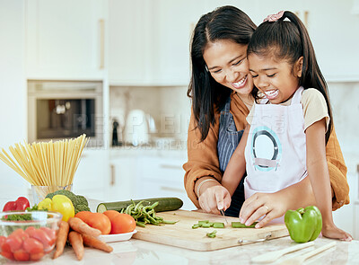 Buy stock photo Cooking, health and mother and girl in kitchen for food, learning and salad together. Help, support and smile with mom and child chef at table in family home for happy, dinner and nutrition diet
