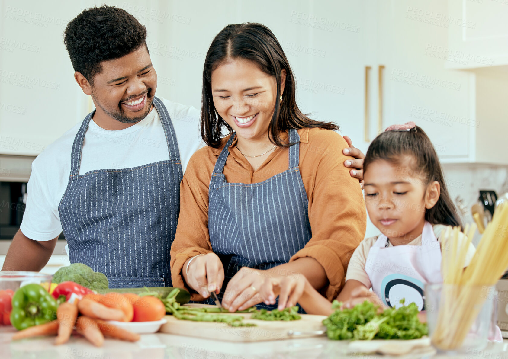 Buy stock photo Family, food and cooking in kitchen for health, wellness and nutrition with vegetables and happy people. Happy family, girl and parents bonding while preparing a balanced meal in their home together