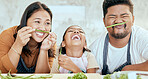 Happy asian family, play vegetables kitchen in portrait and smile together at table for bonding time. Mom dad, child happiness in comic home and health food in nutrition diet, dinner and kid cooking