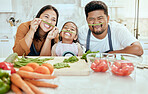 Cooking, family and comic portrait in kitchen for crazy, goofy and silly fun together with smile. Food, asian and bonding with funny vegetable face of happy mother, father and child in house.

