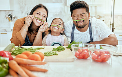 Buy stock photo Cooking, family and comic portrait in kitchen for crazy, goofy and silly fun together with smile. Food, asian and bonding with funny vegetable face of happy mother, father and child in house.

