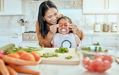 Buy stock photo Mother, child and have fun cooking in kitchen together with teamwork to cut chillies, peppers and vegetables on counter for lunch. Happy, girl with smile and mom teach kid healthy food recipe at home