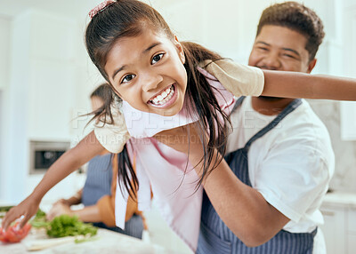 Buy stock photo Family, kitchen and cooking together, smile in portrait and father lift child, learning and chef skill with parents and kid. Happy, food preparation and meal, man holding child and mother with veg.