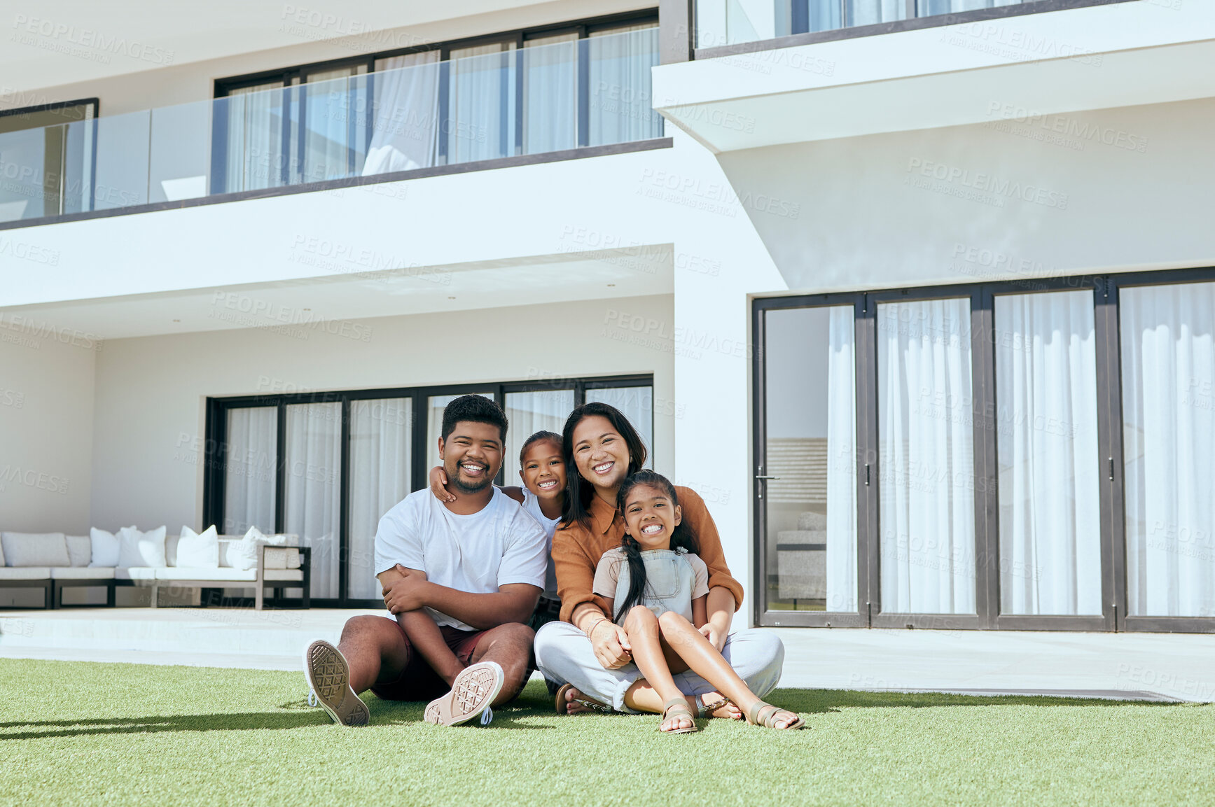 Buy stock photo Happy family, real estate portrait and smile on grass outdoors, bonding and caring. Relax, love and father, mother and girls or children enjoying time together sitting on lawn in backyard of home.