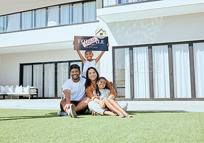 Buy stock photo Property, happy family and sold sign with smile, relax and excited people rest, sit and bond on grass. Real estate, house sale and family moving into new home together, joy and carefree relocating