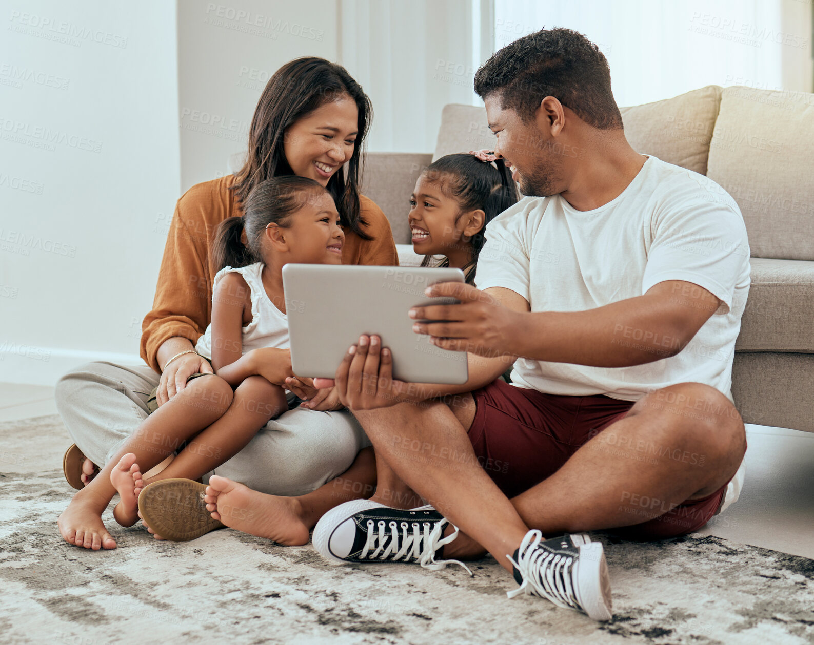 Buy stock photo Family in living room, children smile with tablet video call online or streaming movies in Indonesia home. Indian mother sitting on floor, kids watch content on digital technology and happy father