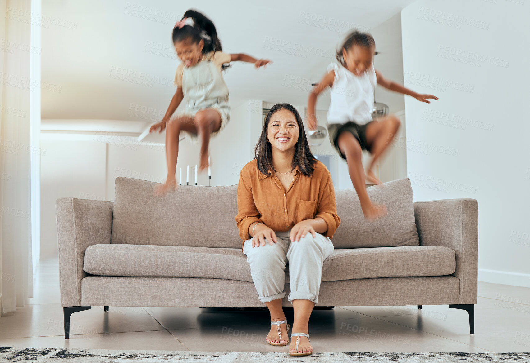 Buy stock photo Family, mom and kids jumping on sofa having fun, energetic and hyper at home. Happiness, joy and portrait of mother sitting with excited children jump on couch, play and relax together on weekend