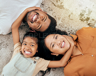 Buy stock photo Love, floor and portrait of relax happy family having fun, bond and enjoy quality time together while lying on ground carpet. Happiness, big smile and Malaysia vacation for parents and child top view