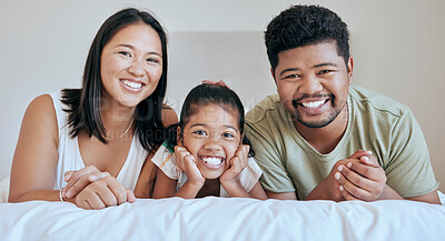 Buy stock photo Family, children and bed with a mother, father and daughter lying in a bedroom of their home together. Relax, love and portrait with a man, woman and girl bonding in the house on a weekend morning