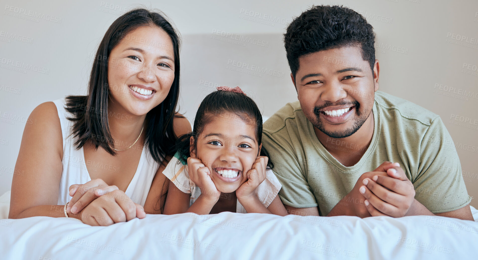 Buy stock photo Family, children and bed with a mother, father and daughter lying in a bedroom of their home together. Relax, love and portrait with a man, woman and girl bonding in the house on a weekend morning