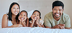 Happy, relax and family on a bed for peace, calm and smile together in their house. Portrait of young, excited and funny children in the bedroom with their mother and father for happiness and love