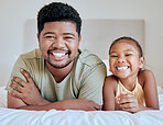 Asian, dad and girl on bed, lying and together with smile, happy and portrait in bedroom in house. Father, child and happiness in room for bonding, time and care while relax in family home in Jakarta