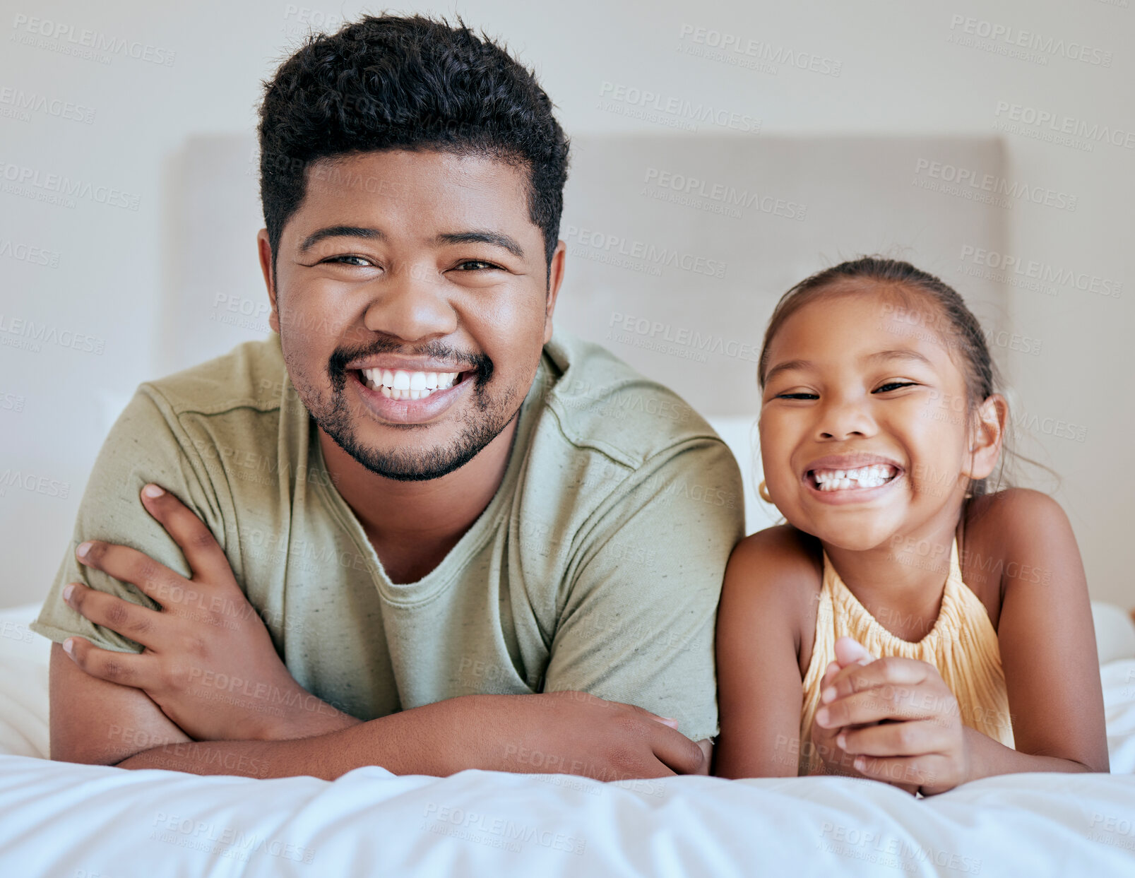 Buy stock photo Asian, dad and girl on bed, lying and together with smile, happy and portrait in bedroom in house. Father, child and happiness in room for bonding and care while relax in family home in Jakarta