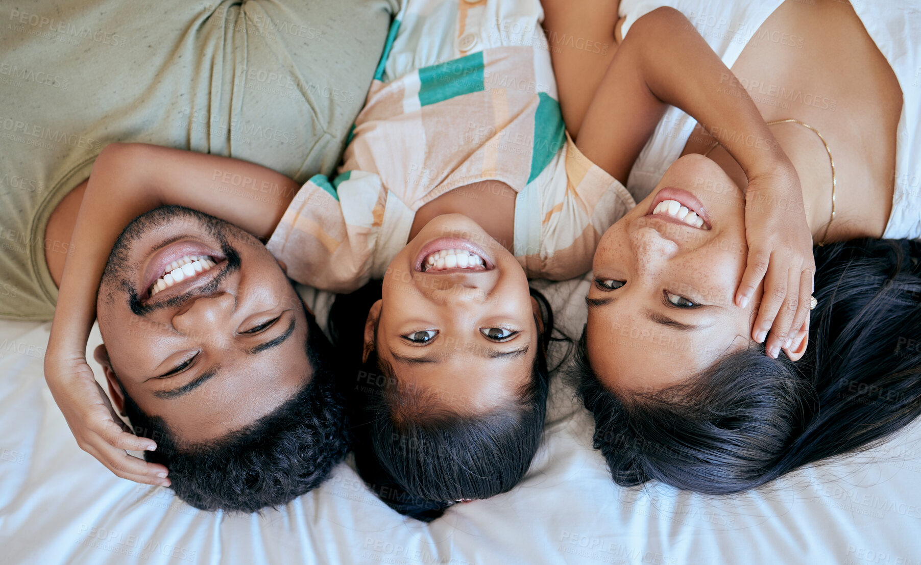 Buy stock photo Portrait of happy or love family lying cosy on bed while bond together at home. Loving parents spending quality time with little girl. Cute kid smile, enjoy and relax lazy morning with mom and dad