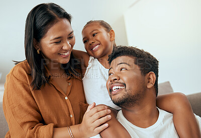 Buy stock photo Love, family and relax on a sofa bonding, smile and embracing in a living room with happy, cheerful people. Happy family, quality time and child with parents having fun and enjoying cosy conversation