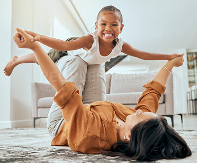Buy stock photo Mother lift girl on floor and play in home living room for family love, care and wellness. Happy kid play fun youth game with mom and bond in house lounge with smile, happiness or relationship