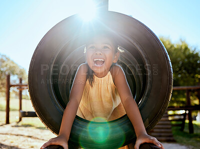 Buy stock photo Child, smile and park on jungle gym, tyre and playing in sunshine, summer and outdoor while excited. Happy, girl and wow for laugh, happiness and playground in lens flare, comic and nature in Orlando