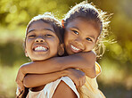 Girl, hug and love, sisters and happy in portrait together, young kids outdoor and family bonding in nature. Indian children smile, sibling relationship and care, spending quality time in park.