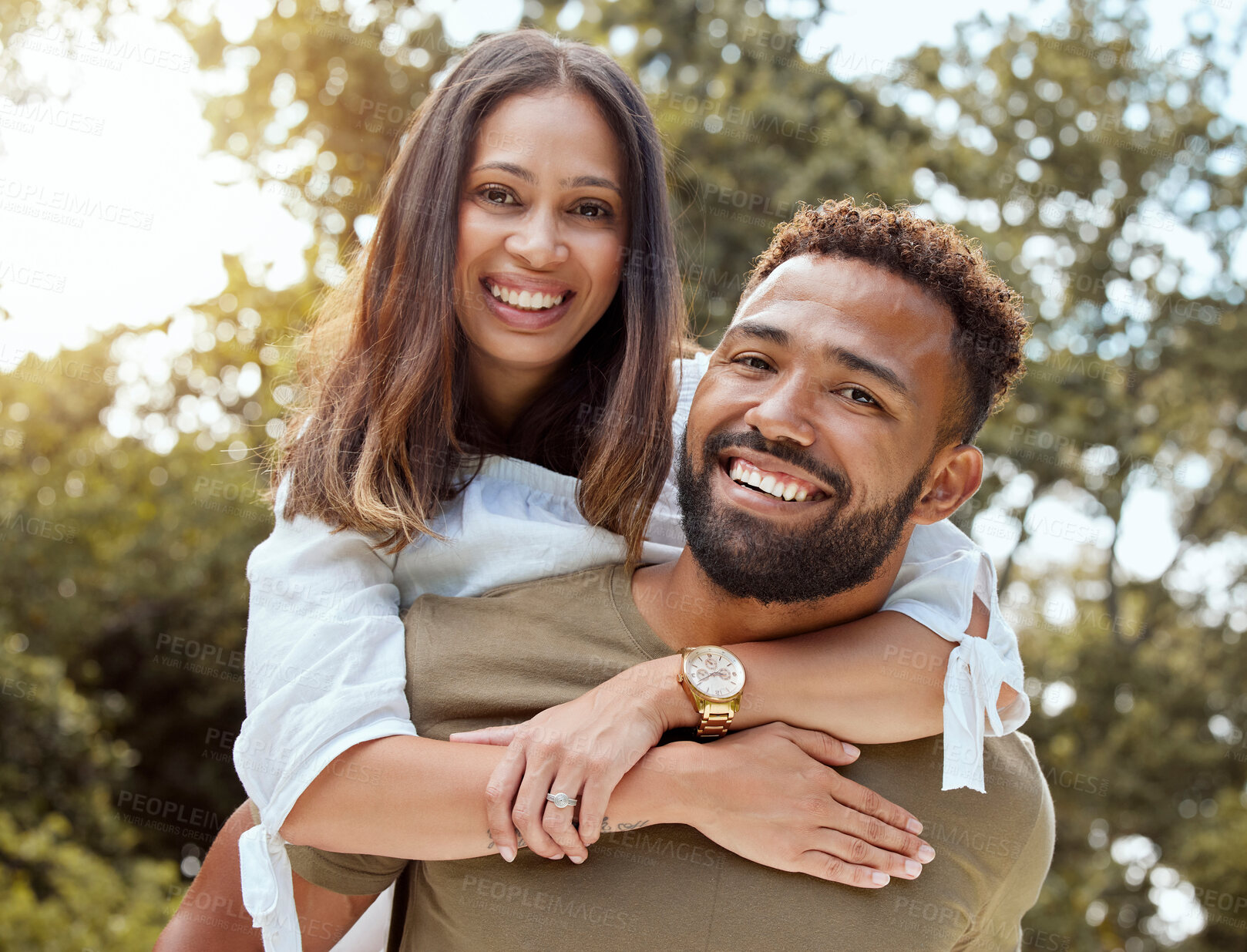 Buy stock photo Love, black couple and with smile hug, bonding and happy together outdoor for fun, loving and embrace. Portrait, romance and man piggy back woman with happiness, marriage, relationship and celebrate.