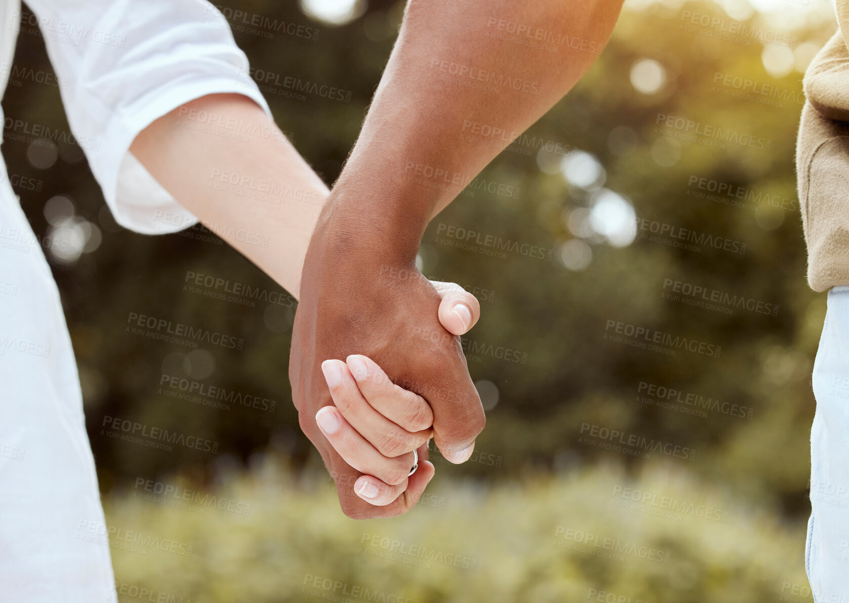 Buy stock photo Diversity, holding hands and couple being romantic, support and being together for relationship, marriage and unity. Multiracial, hand gesture and interracial for romance, outdoor holiday and union.