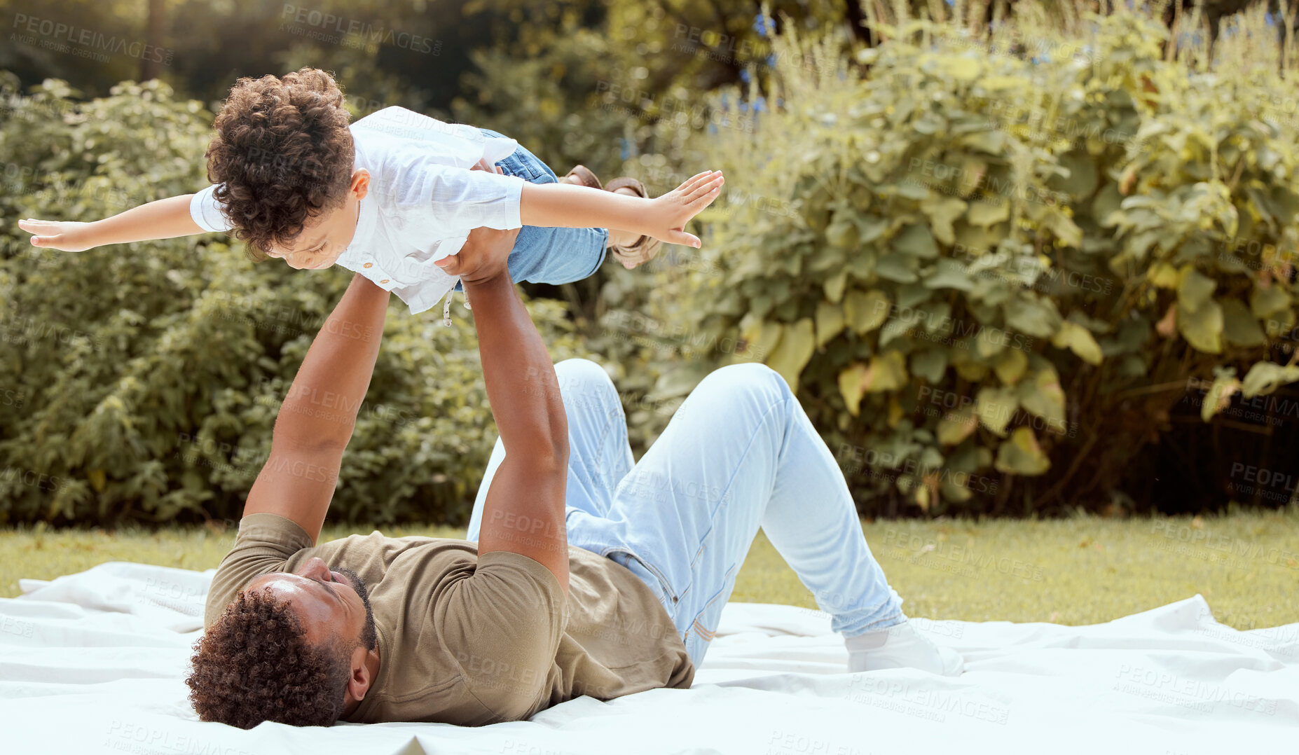 Buy stock photo Father, kid and fun time of a family in a nature park on a picnic blanket with parent love. Child, dad and in the air outside playing of a kid with a man on a summer day with young and care