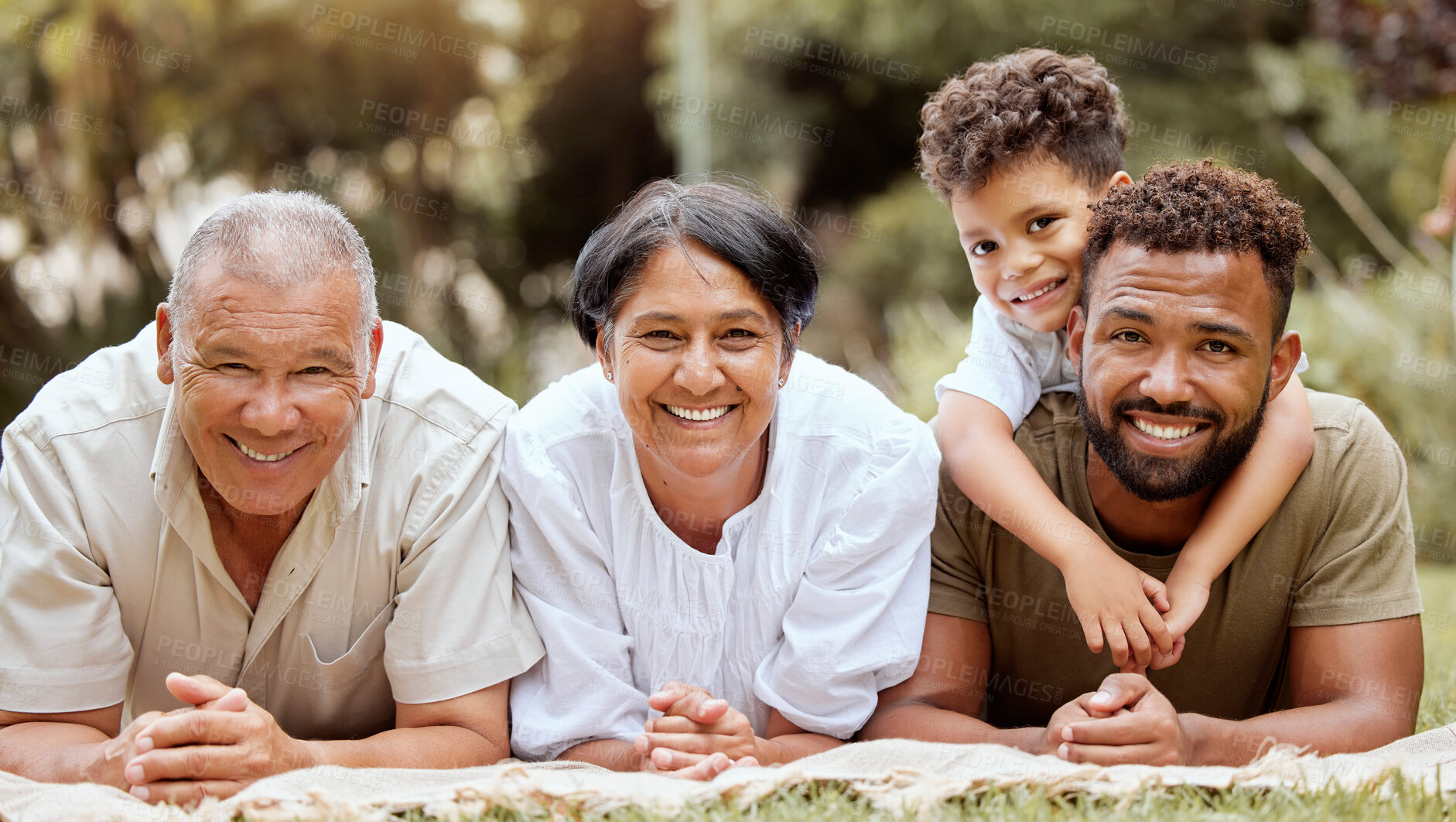 Buy stock photo Nature, grandparents and dad with child on grass in outdoor park on summer holiday. Happy, smile and relax, portrait of family on garden picnic blanket, fun for men, woman and kid together in Brazil