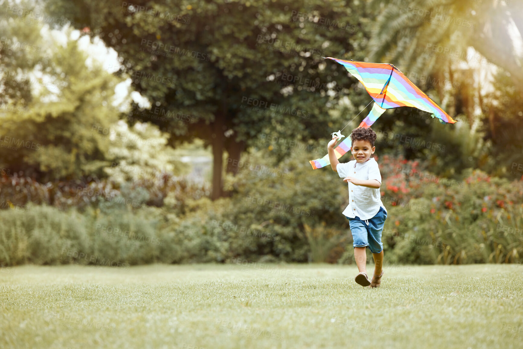 Buy stock photo Child, kite and grass while running for wind to lift, air and sky while play, fun and happy outdoor. Boy, toys and lawn in garden, backyard or park in sunshine, summer and nature while playing