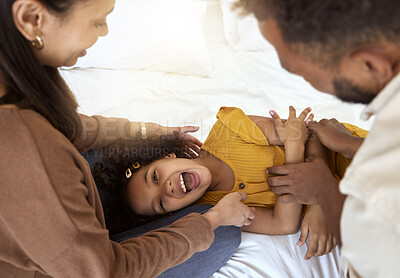 Buy stock photo Family tickle, playing and girl with happy parents bonding with quality time together at a home. Laughing, smiling and happiness of a child smile with a mom, father and care on a bedroom bed  