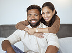 Couple, smile and sofa for portrait with back, woman or love in living room while home together. Black woman, man and happy for embrace, care or hug on couch with happiness, face and bonding on couch
