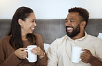 Couple, coffee and laughing people feeling happiness in a home living room lounge sofa. Happy, funny and smile in the morning of a girlfriend and boyfriend together on a house couch with quality time