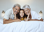 Girl, grandparents and smile on bed for portrait, together and bedroom for bonding, love and happy in home. Elderly, man and woman with child for happiness, embrace and care in room at family house
