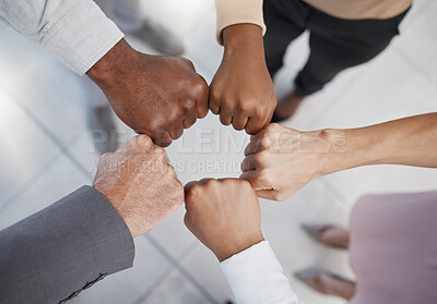 Buy stock photo Diversity, hands and team fist above in support, trust and unity for collaboration, agreement or meeting at the office. Group hand of diverse people in teamwork, cooperation and solidarity for fight