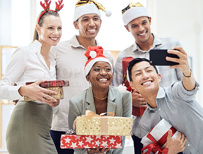 Buy stock photo Happy, office and christmas party selfie of a corporate event with diversity staff on a phone. Business worker, friends and employee group together with a smile, gift and celebration for a holiday