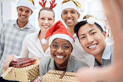 Buy stock photo Selfie, Christmas and employees with gift at a party, celebration and smile in office together at work. Portrait of young, happy and team of business workers with present and photo at corporate event