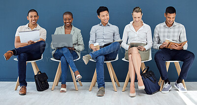 Buy stock photo Recruitment, chair and row of people with interview preparation notes in book, laptop or tablet. Hiring, diversity and candidate group getting ready with optimistic smile for work opportunity.
