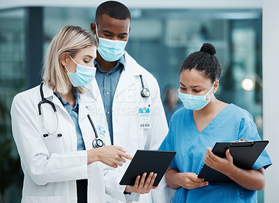 Buy stock photo Doctor, tablet and covid team for healthcare, research or diagnosis in collaboration together at the hospital. Diverse group of medical professionals wearing masks looking at touchscreen in clinic