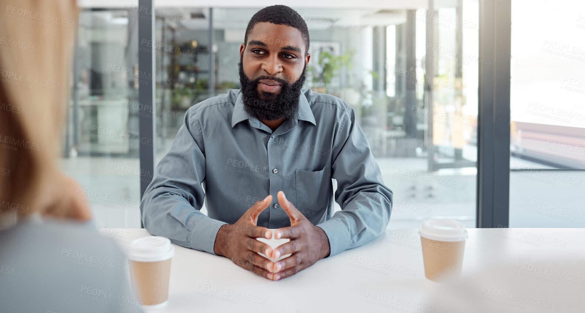 Buy stock photo Black man, business meeting and job interview have discussion, conversation for work and recruitment. Confident employee, young male and smile ready to speak, talking and negotiation for employment 
