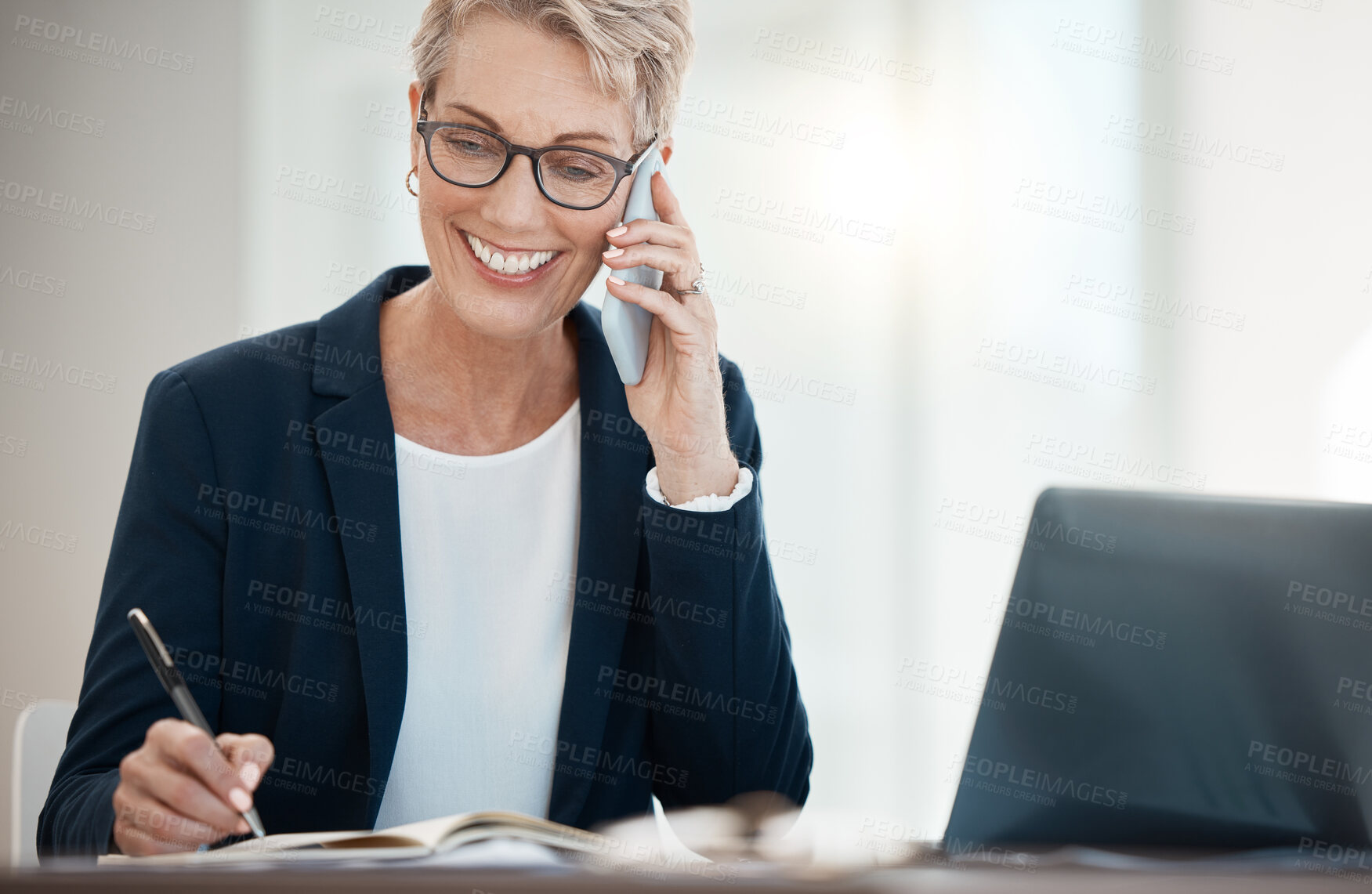 Buy stock photo Mature business woman, phone call and notebook writing in company finance, investment and stock market sales negotiation. Smile, happy and talking financial broker on laptop or mobile tech networking