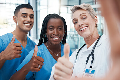 Buy stock photo Selfie, doctor and students with thumbs up portrait at hospital for success, diversity and healthcare. Interracial, teamwork and agreement of professional medical people with smile for cooperation.

