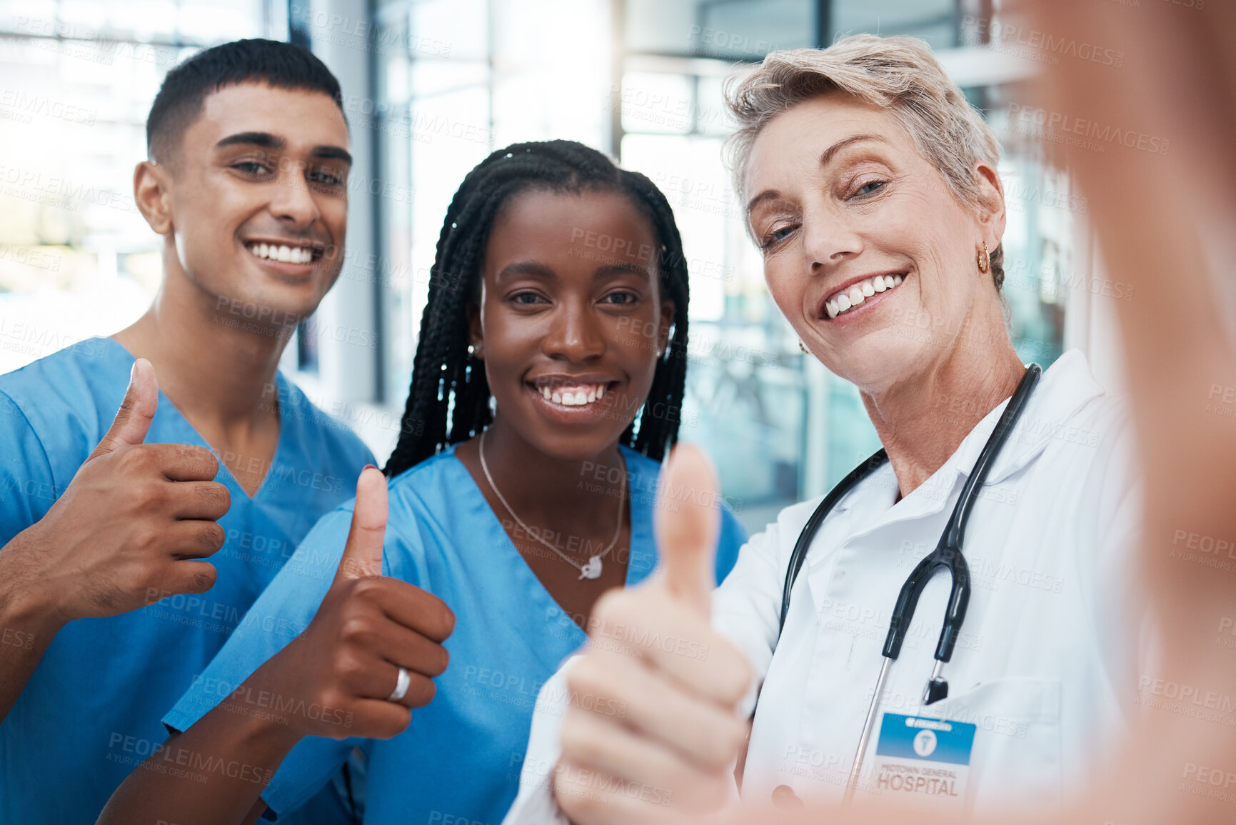 Buy stock photo Selfie, doctor and students with thumbs up portrait at hospital for success, diversity and healthcare. Interracial, teamwork and agreement of professional medical people with smile for cooperation.

