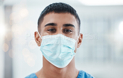 Buy stock photo Covid, healthcare and medicine with a man nurse using a mask in a hospital for health or safety. Portrait, medical and facemask with a male medicare or nursing professional standing alone in a clinic